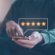 Person giving a five star review on a cell phone