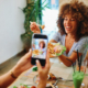 Two friends capturing a fun dining moment with a smartphone